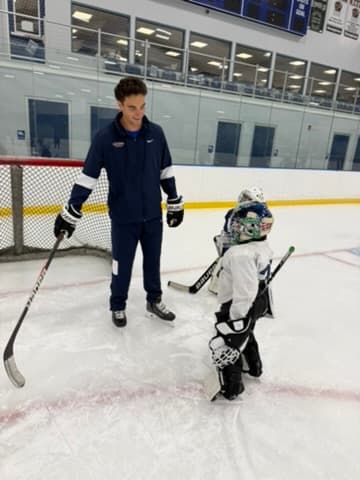 Lucas Hrabkovsky coaching a young goalie
