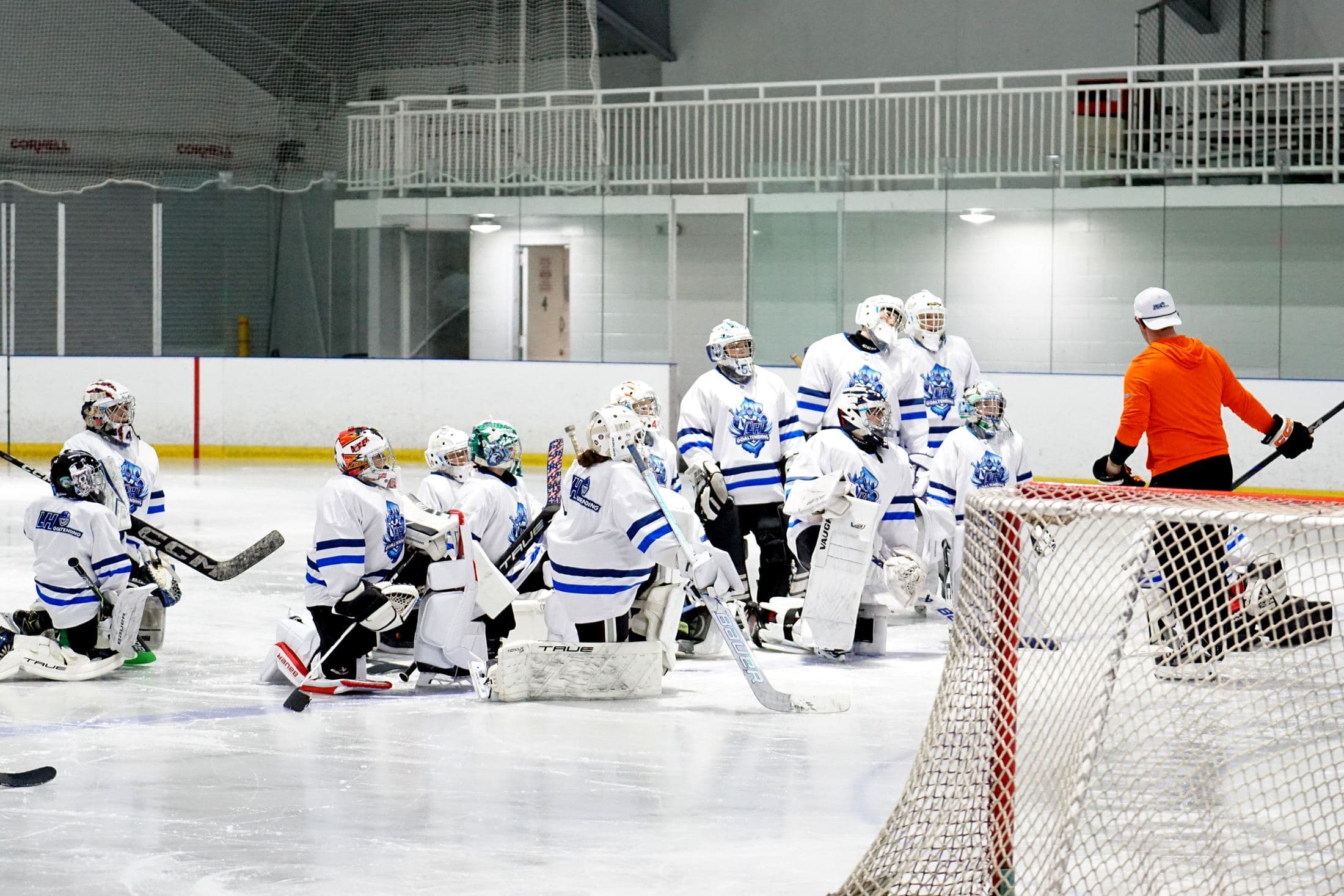 LH Goaltending camp goalies gathered around the net during a session