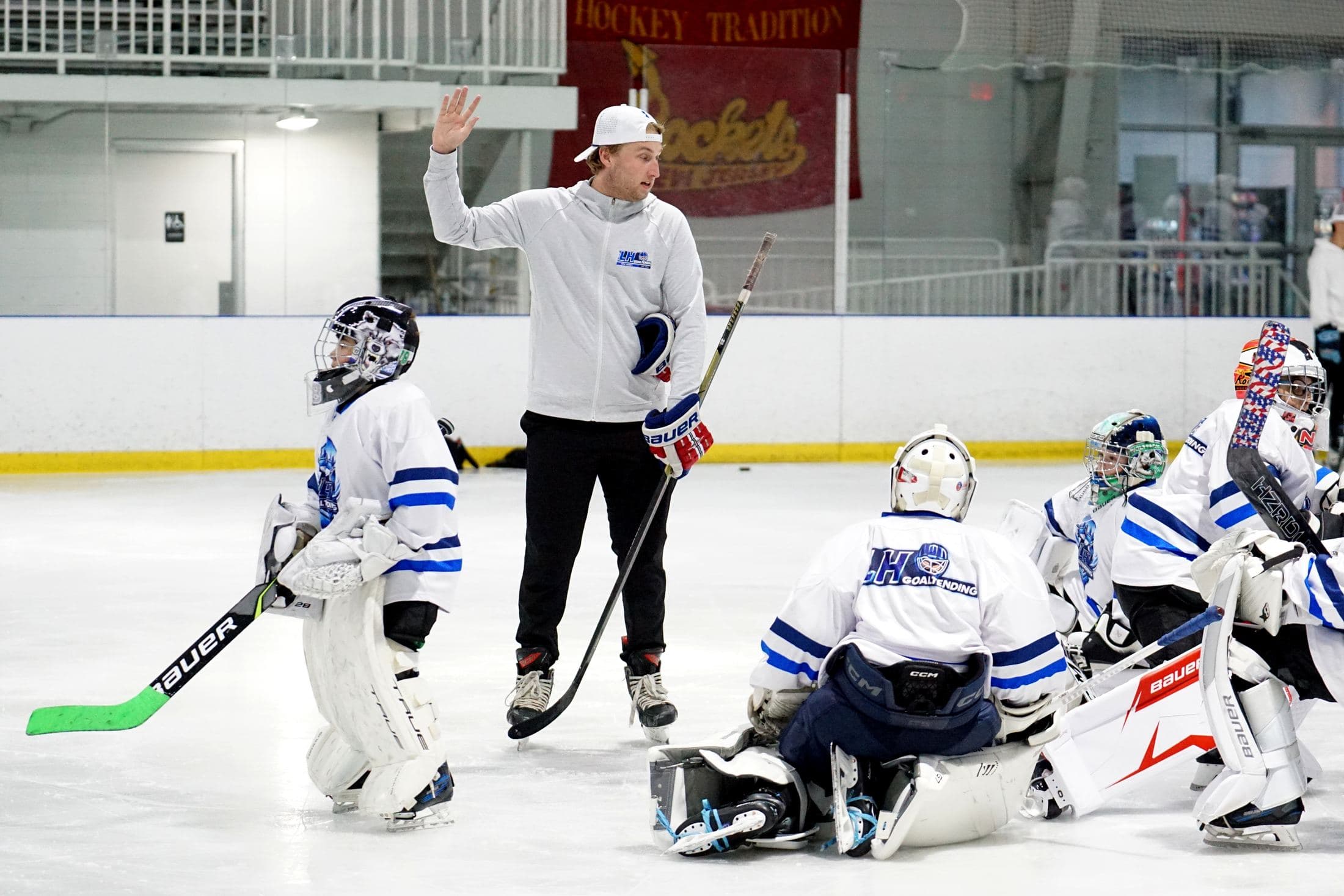 Coach Lucas Hrabkovsky instructing a group of goalies at an LH Goaltending camp