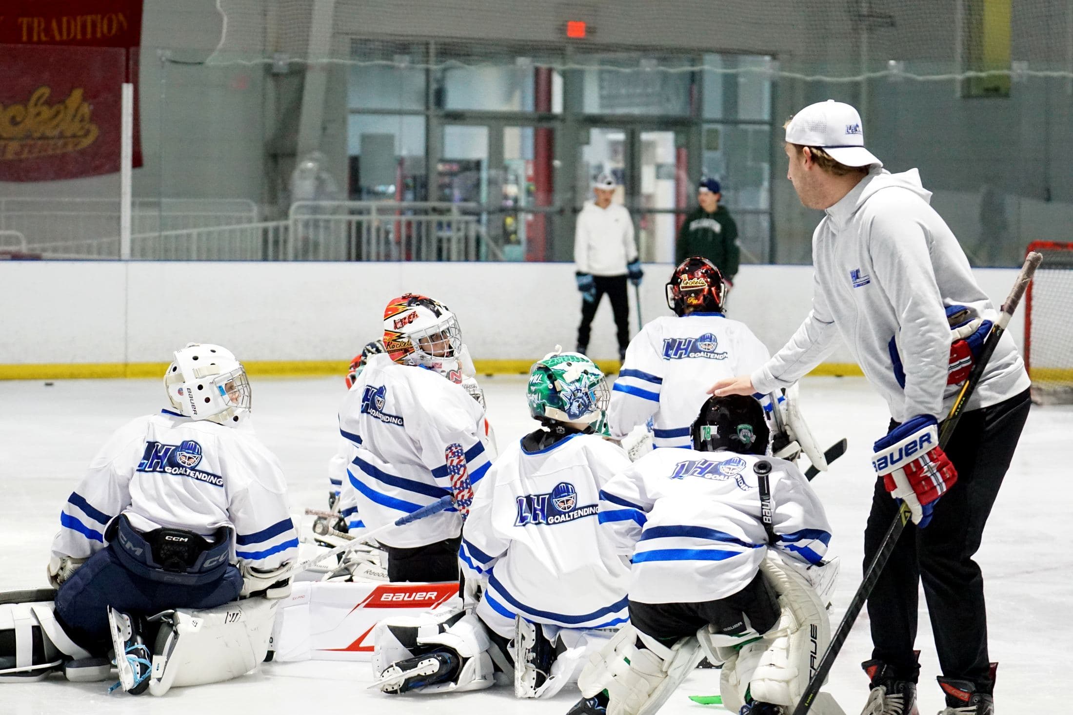 LH Goaltending camp group on the ice listening to the coach