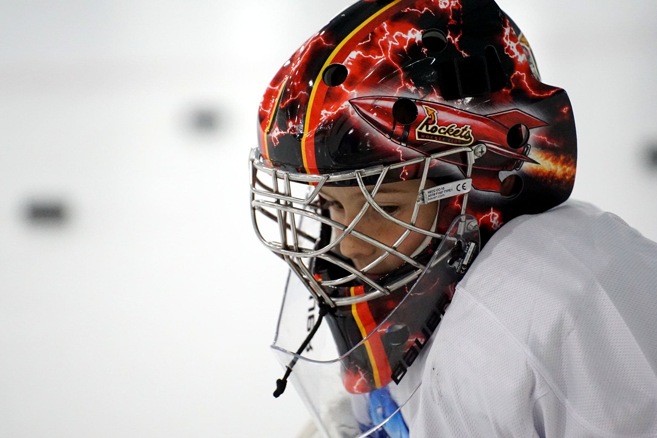Close-up of a young goalie in a painted mask at an LH Goaltending session