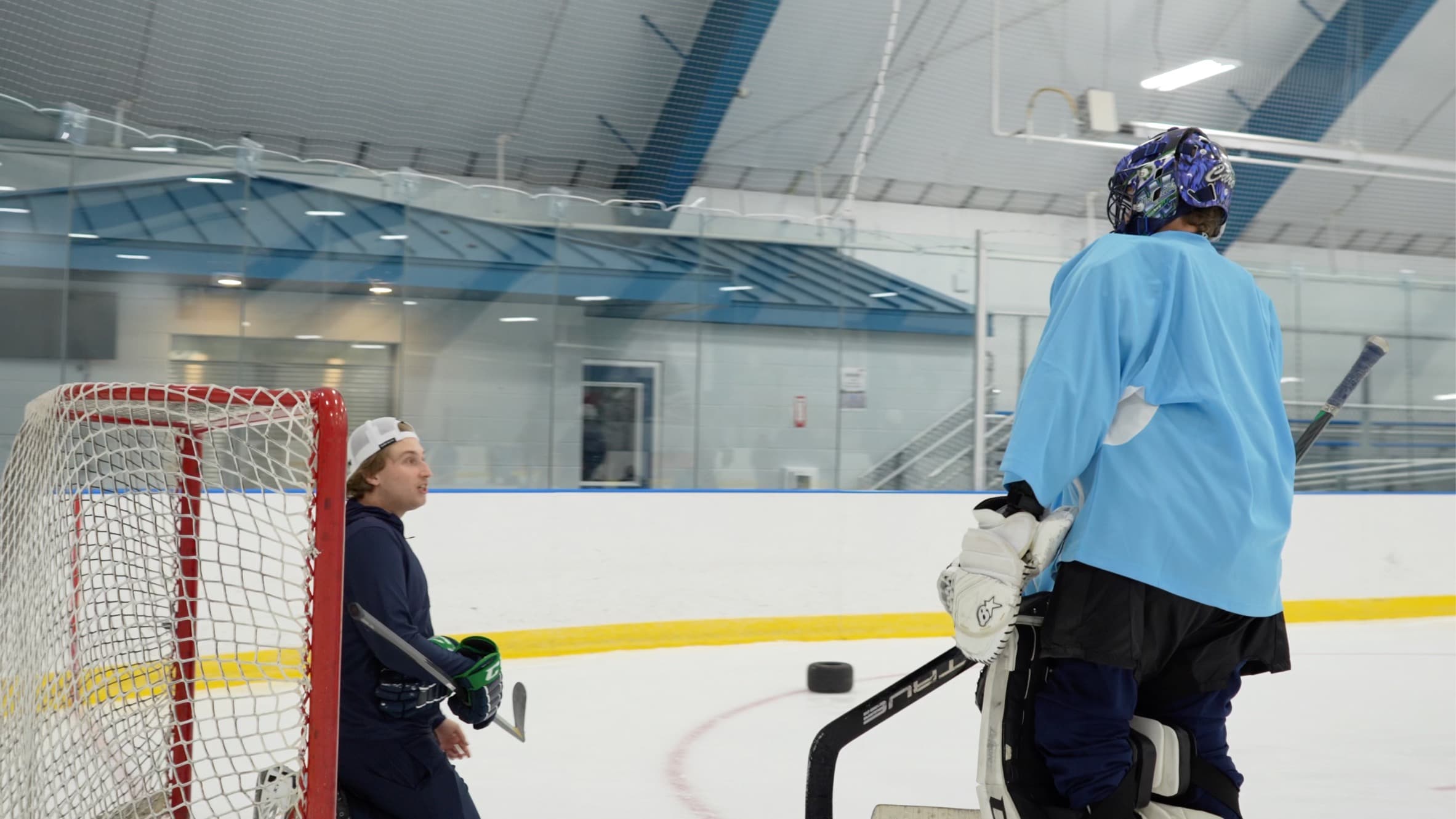 Goalie working through a drill with a coach